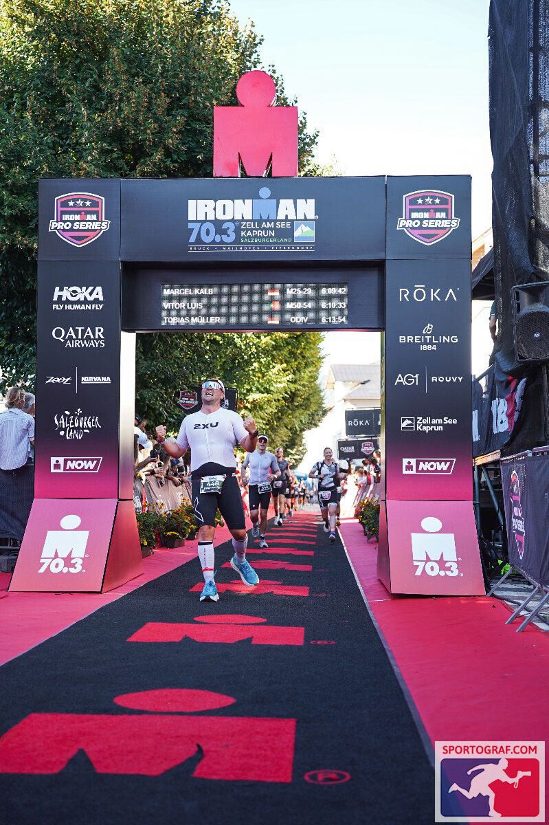 Ralph Mitchell crossing the Ironman finish line